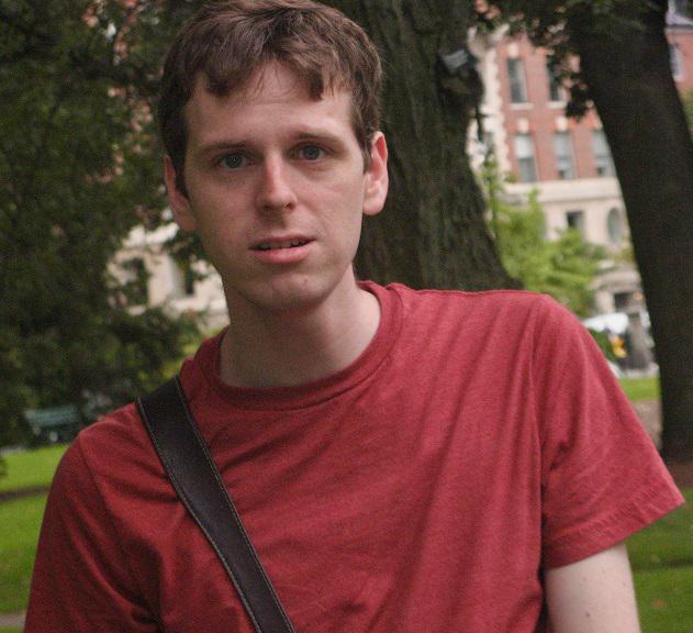 Jimmy looks very unpleased as a bird has just pooped on his shoulder. The picture was taken at the Boston Commons.